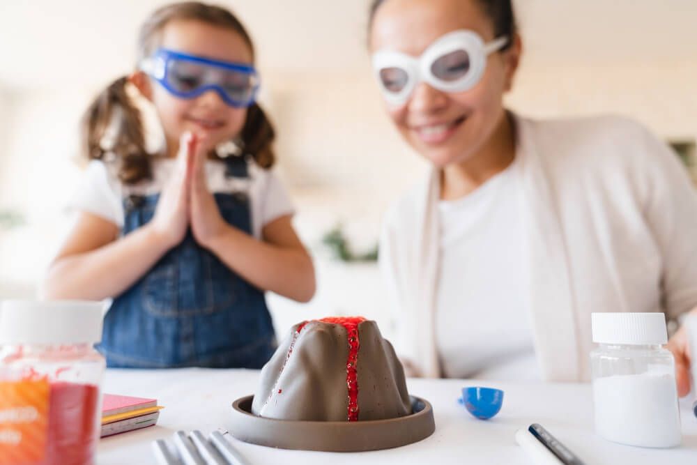 A student and a teacher wear a safety glasses in the some chemical event